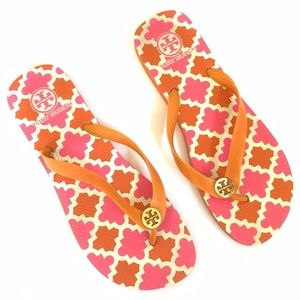 Tory Burch orange and pink flip flops.